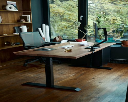 Organized workspace with high quality natural light and wooden desk